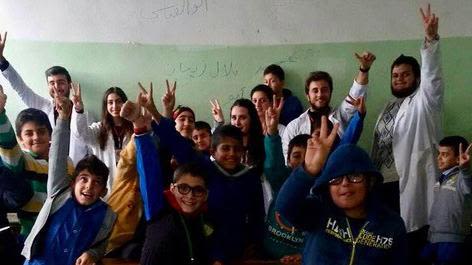 Naseem AlKhoury (back row, far left) helped deliver lessons in basic health to primary school children, as part of the RED Blood Cells Project in Syria