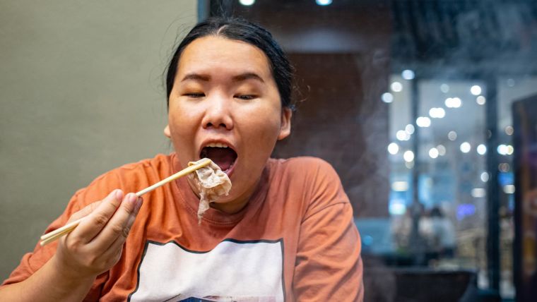 Chinese woman eating meat