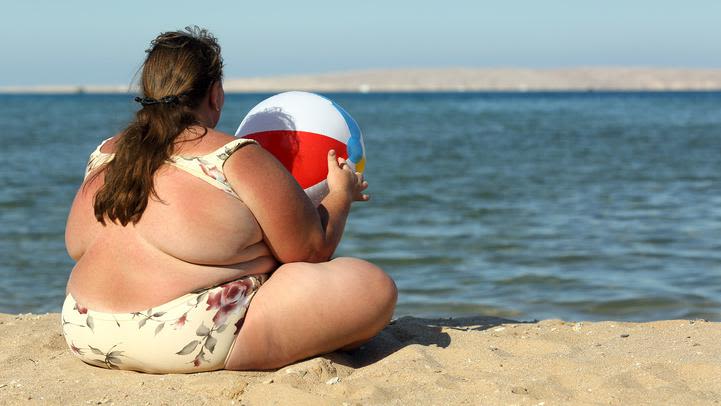 Obese woman on a beach.