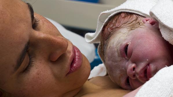 Mother holding newborn baby.